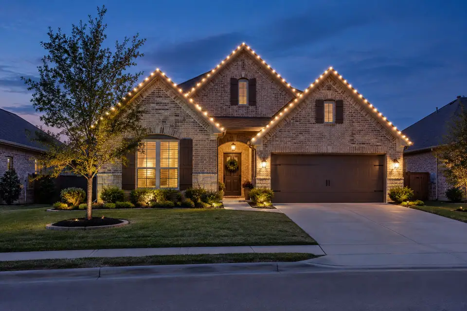 Residential Christmas lighting inspiration for a Cibolo brick home facing a neighborhood street