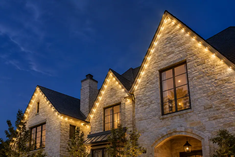 Concept of a lit roofline on a Hill Country house